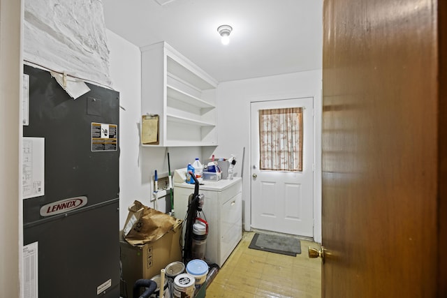 laundry area featuring separate washer and dryer and heating unit