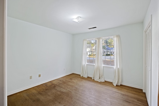 unfurnished bedroom with hardwood / wood-style floors