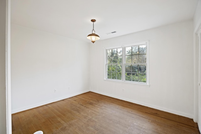 unfurnished room with hardwood / wood-style flooring