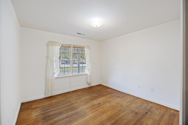 unfurnished room featuring hardwood / wood-style flooring