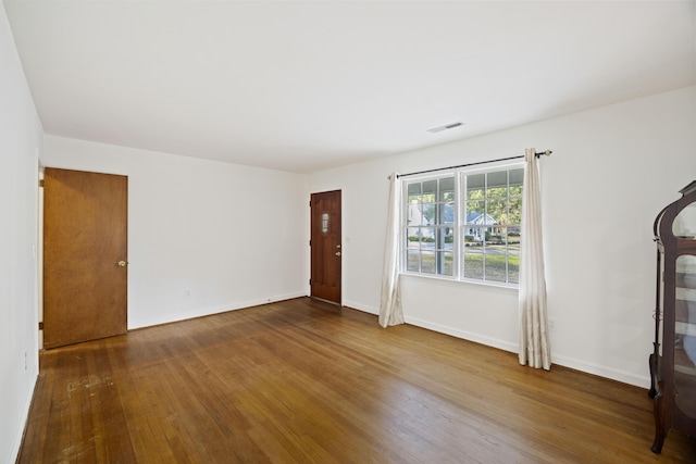 unfurnished living room featuring hardwood / wood-style flooring