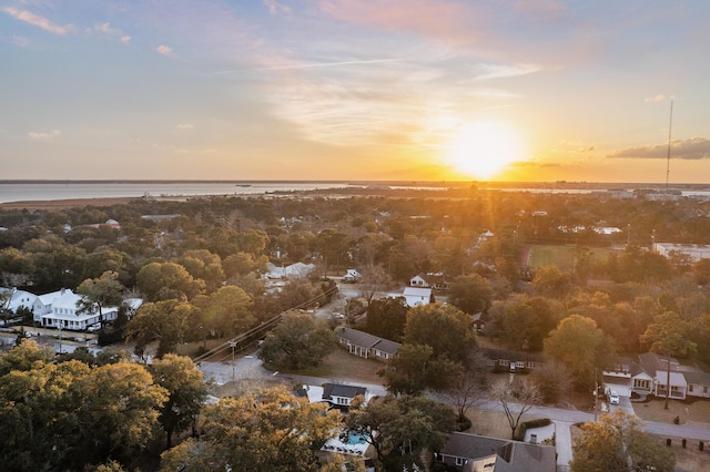 aerial view at dusk featuring a water view