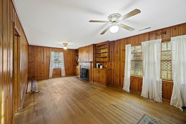 unfurnished living room with hardwood / wood-style flooring and ceiling fan