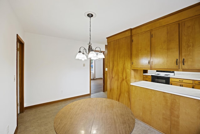 kitchen featuring an inviting chandelier, hanging light fixtures, and oven