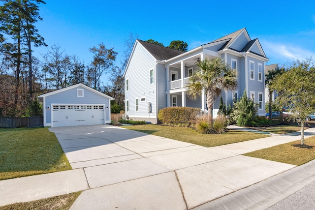 view of front of house featuring an outdoor structure, a balcony, a front yard, and a garage