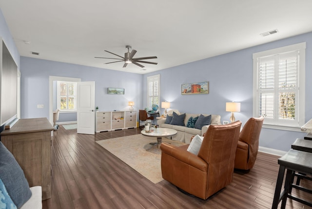 living room with dark hardwood / wood-style floors and ceiling fan