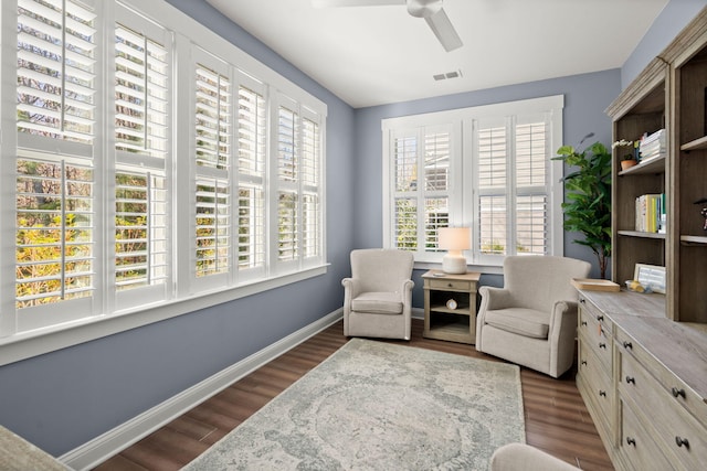 sitting room featuring dark hardwood / wood-style floors and ceiling fan