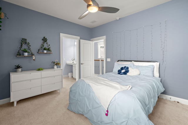 bedroom featuring ensuite bath, ceiling fan, and light colored carpet