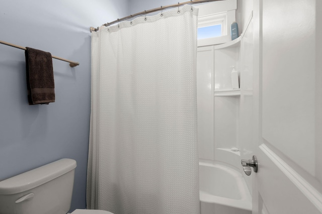 bathroom featuring shower / bath combo and toilet