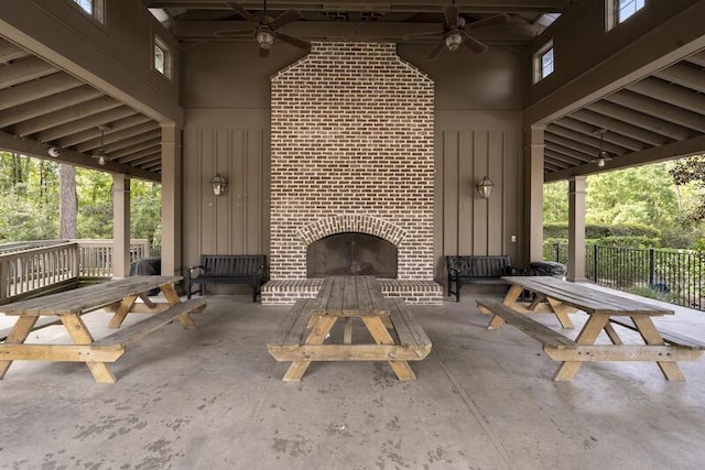 view of patio / terrace with an outdoor brick fireplace and ceiling fan