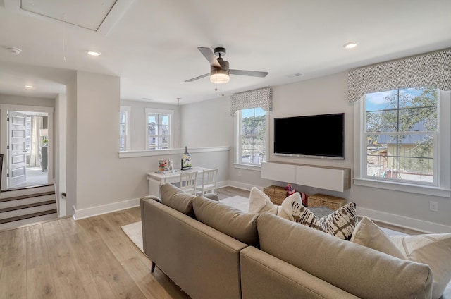 living room featuring light hardwood / wood-style floors and ceiling fan