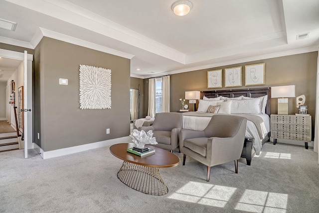 carpeted bedroom with ornamental molding and a tray ceiling