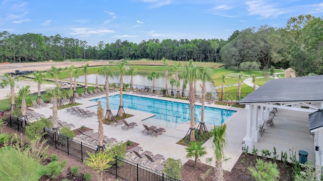 view of pool featuring a patio and a water view