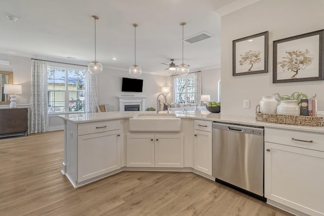 kitchen with sink, white cabinetry, hanging light fixtures, ornamental molding, and stainless steel dishwasher