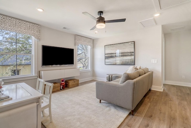 living room featuring hardwood / wood-style flooring and ceiling fan