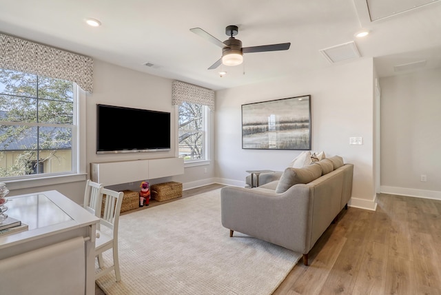 living room featuring ceiling fan and light hardwood / wood-style floors