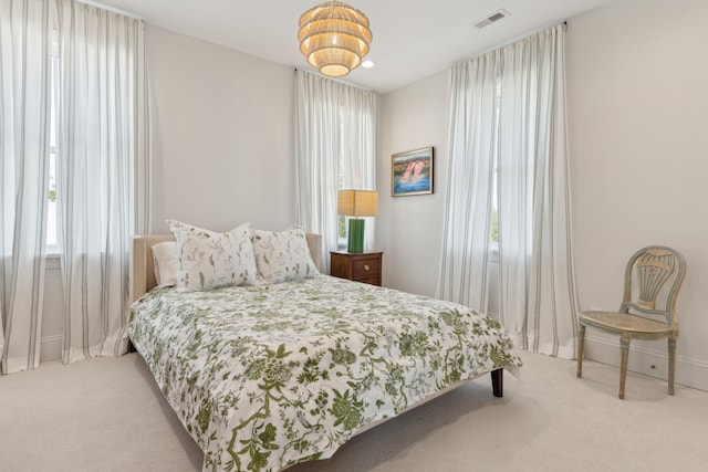 carpeted bedroom with multiple windows