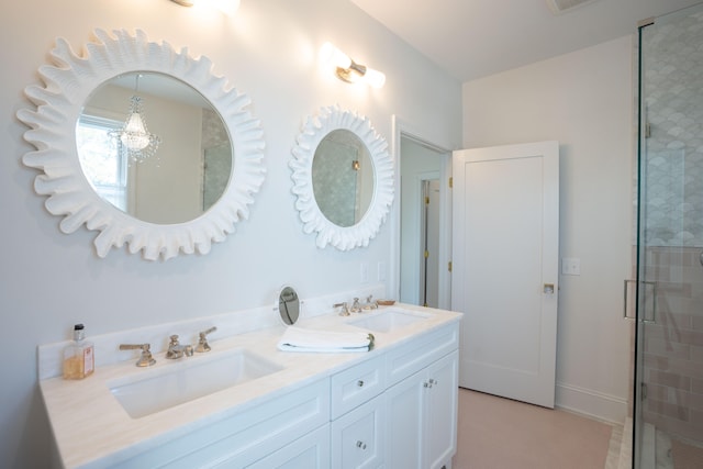 bathroom with vanity, a shower with shower door, and an inviting chandelier