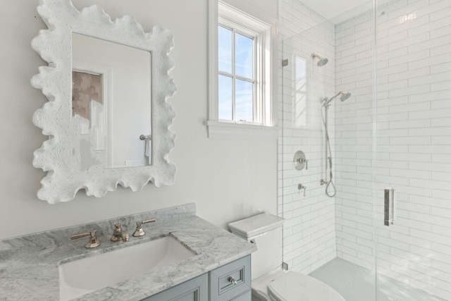 bathroom with vanity, an enclosed shower, and toilet