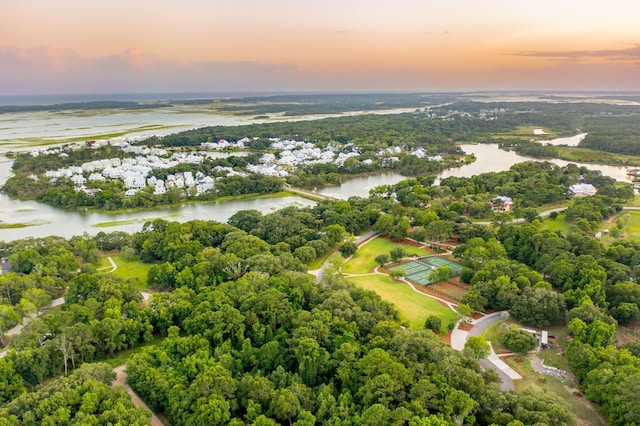 aerial view at dusk featuring a water view