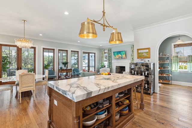 kitchen featuring french doors, a center island, light hardwood / wood-style floors, and ornamental molding