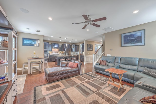 living room with dark wood-type flooring and ceiling fan