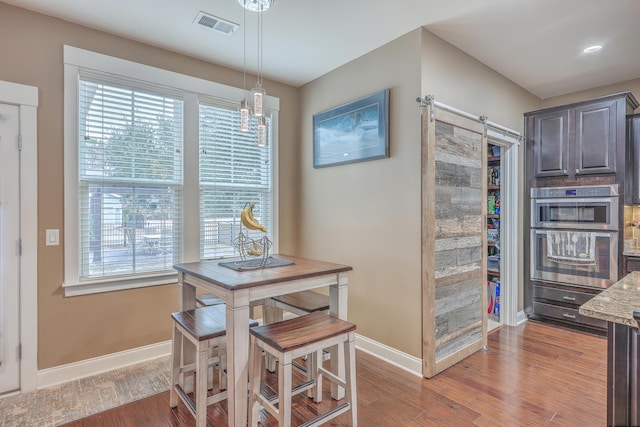 dining room with a notable chandelier and hardwood / wood-style floors