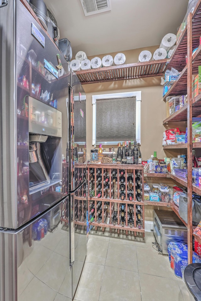 wine area with tile patterned flooring and a workshop area