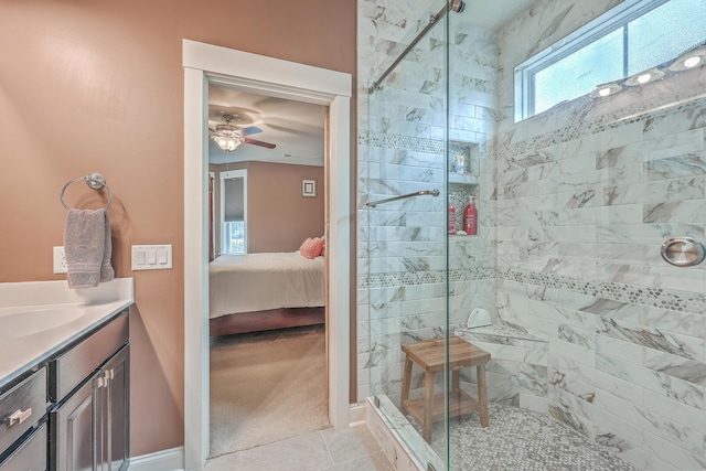 bathroom with vanity, walk in shower, tile patterned floors, and ceiling fan