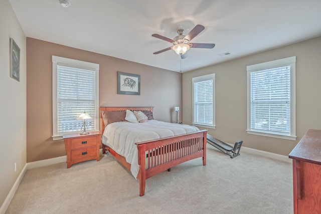 bedroom with light carpet and ceiling fan