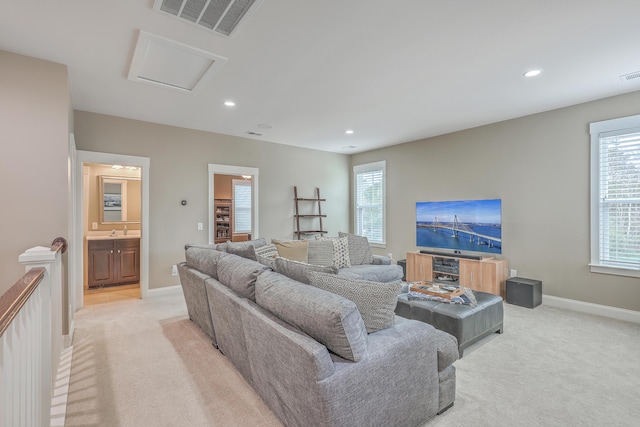 living room with light colored carpet and a wealth of natural light