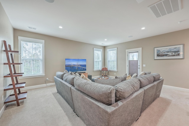 living room with a healthy amount of sunlight and light carpet