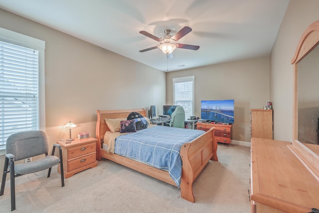 bedroom with light carpet and ceiling fan