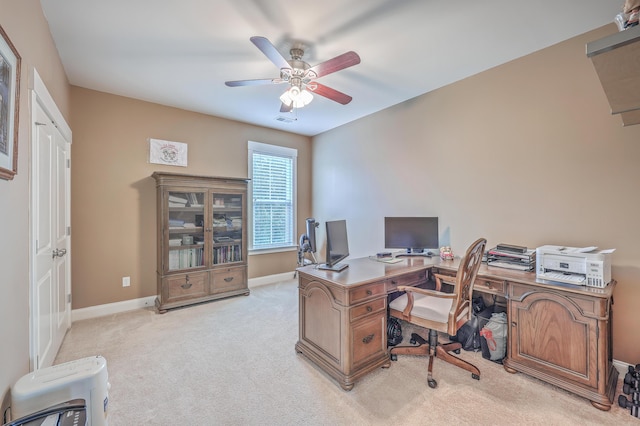 home office featuring ceiling fan and light carpet