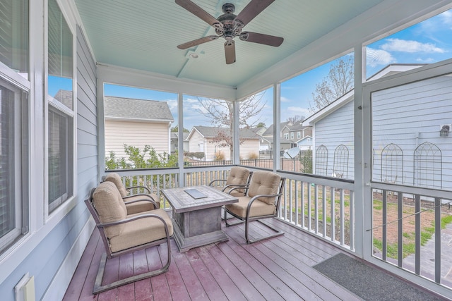 sunroom / solarium featuring ceiling fan and a wealth of natural light