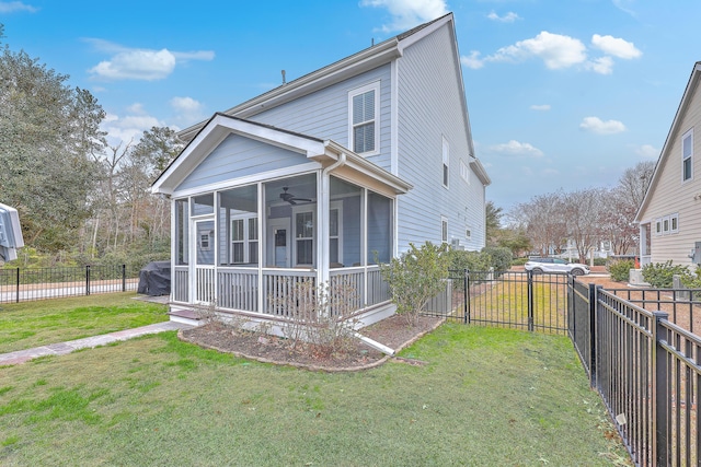 exterior space featuring ceiling fan, a yard, and a sunroom