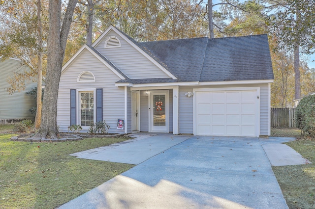 view of front of property with a garage and a front lawn