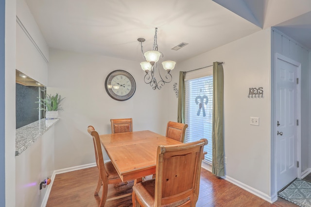 dining area with a notable chandelier and light wood-type flooring