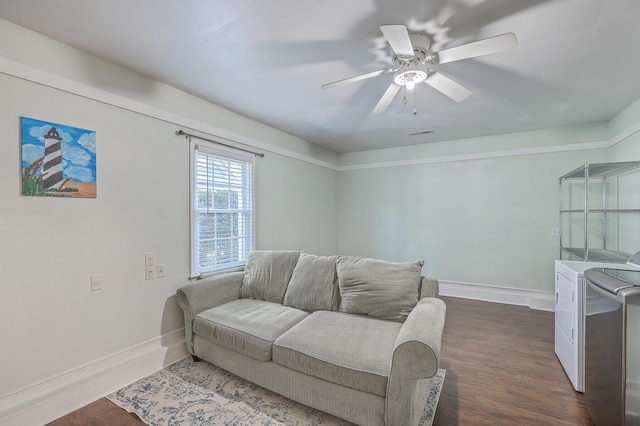 living room with dark hardwood / wood-style floors, ceiling fan, and separate washer and dryer