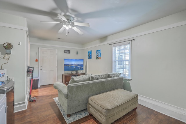 living room featuring dark hardwood / wood-style flooring and ceiling fan