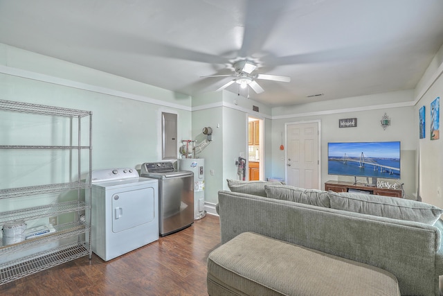 interior space featuring ceiling fan, water heater, dark hardwood / wood-style flooring, independent washer and dryer, and electric panel