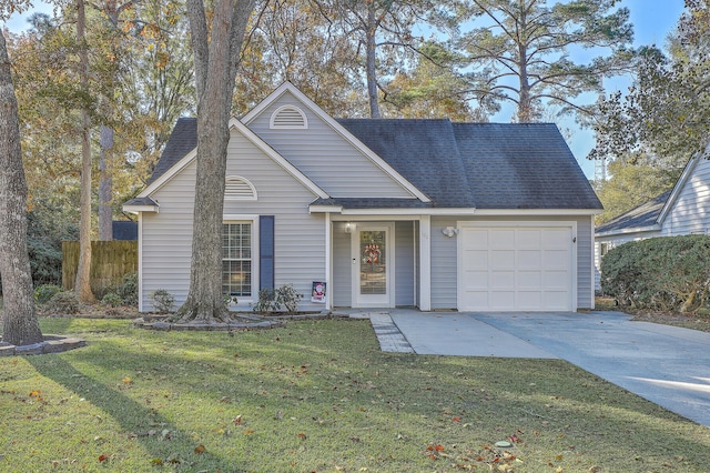 view of front of property featuring a garage and a front lawn