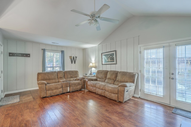 living room featuring dark hardwood / wood-style floors, ceiling fan, french doors, and vaulted ceiling