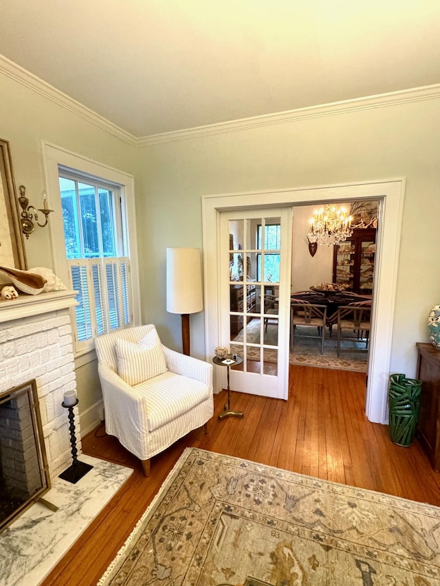 2066 Wappoo Dr, Charleston, SC 29412 - sitting room with ornamental molding, wood-type flooring, a chandelier, plenty of natural light, and a fireplace