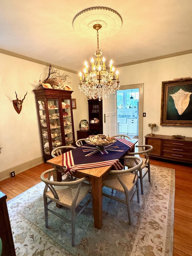 2066 Wappoo Dr, Charleston, SC 29412 - dining area featuring a chandelier, wood finished floors, and crown molding