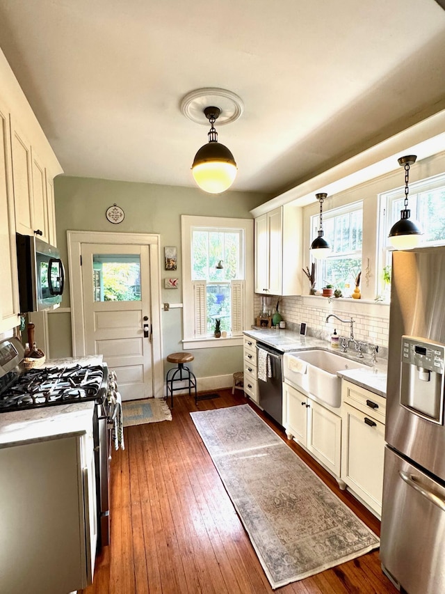 2066 Wappoo Dr, Charleston, SC 29412 - kitchen with stainless steel appliances, backsplash, pendant lighting, and white cabinetry