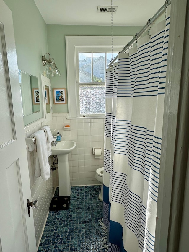2066 Wappoo Dr, Charleston, SC 29412 - full bathroom with tile walls, wainscoting, curtained shower, and tile patterned flooring
