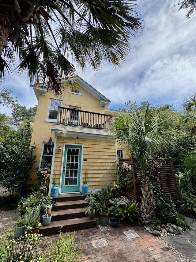 2066 Wappoo Dr, Charleston, SC 29412 - back of house featuring a balcony, entry steps, and stucco siding