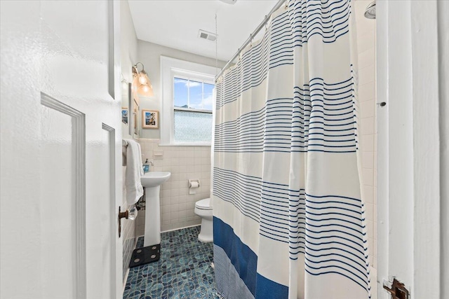 2066 Wappoo Dr, Charleston, SC 29412 - full bath featuring tile walls, tile patterned floors, a wainscoted wall, and curtained shower