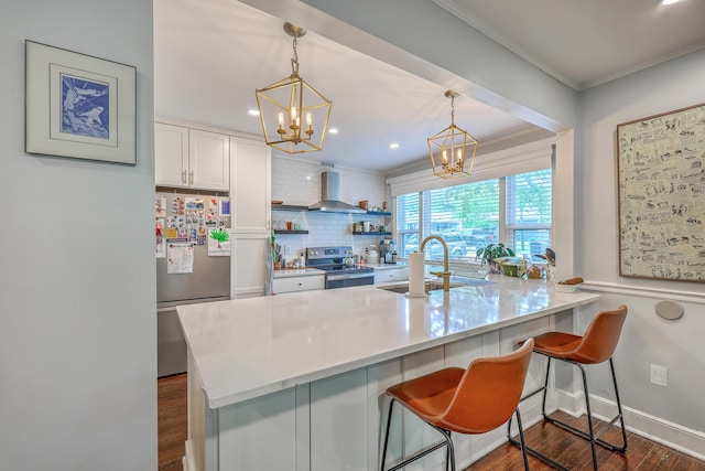 1188 Camden St, North Charleston, SC 29405 - kitchen featuring appliances with stainless steel finishes, a chandelier, decorative backsplash, white cabinetry, and dark wood finished floors